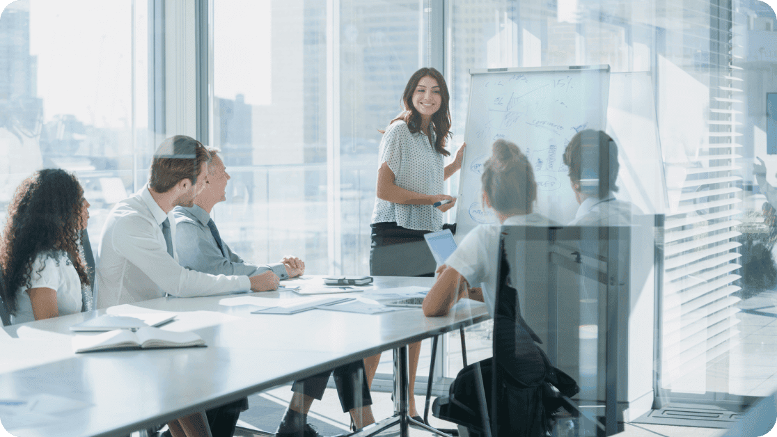 Group of professionals working together in a high-rise conference room. 