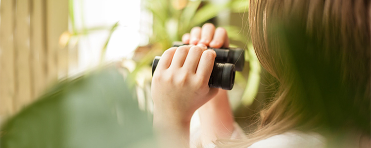 Woman looking through binoculars